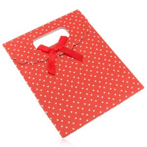 Czerwona upominkowa torebka z papieru z białymi kropkami, czerwona kokarda