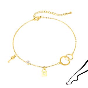 Stalowa bransoletka na kostkę lub rękę, złoty kolor - połączone kółeczka, kłódka, klucz i cyrkonia